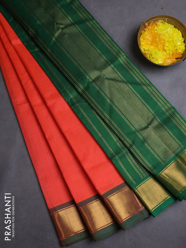 Silk cotton saree orange and green with plain body and zari woven border
