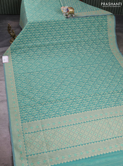 Banarasi silk cotton saree teal shade with allover thread weaves and woven border
