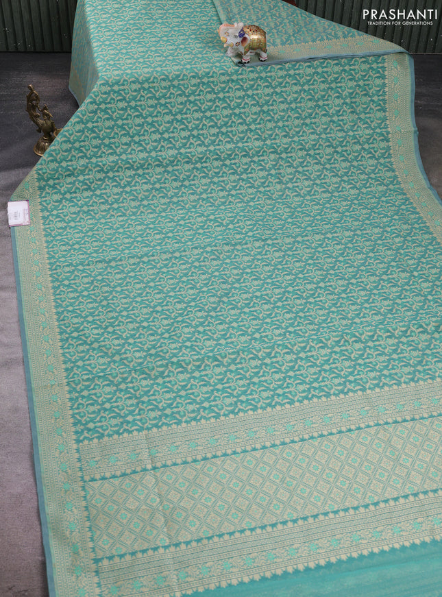 Banarasi silk cotton saree teal shade with allover thread weaves and woven border