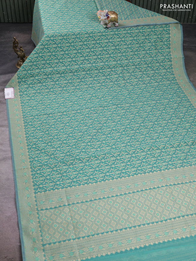 Banarasi silk cotton saree teal shade with allover thread weaves and woven border