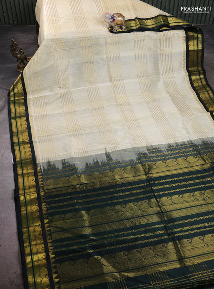 Silk cotton saree off white and dark bottle green with allover zari checked pattern & buttas and zari woven korvai border