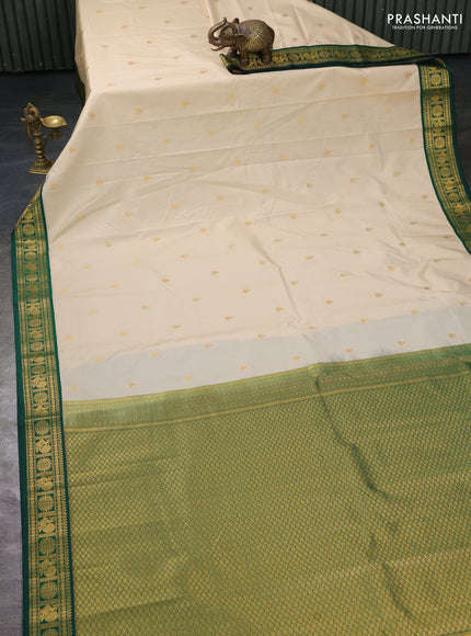 Semi kanchipuram silk saree cream and green with zari woven buttas and zari woven korvai border