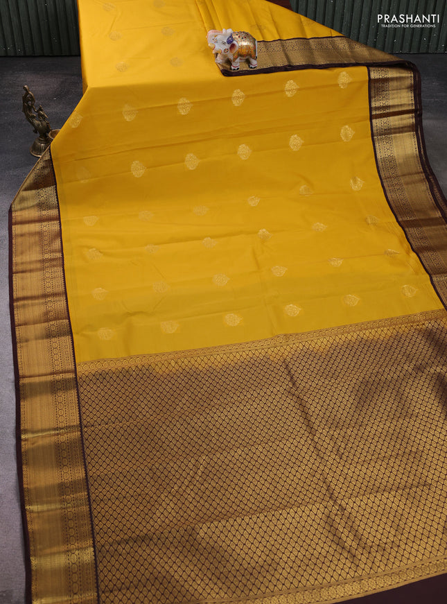 Semi kanchipuram silk saree yellow and coffee brown with zari woven buttas and zari woven korvai border