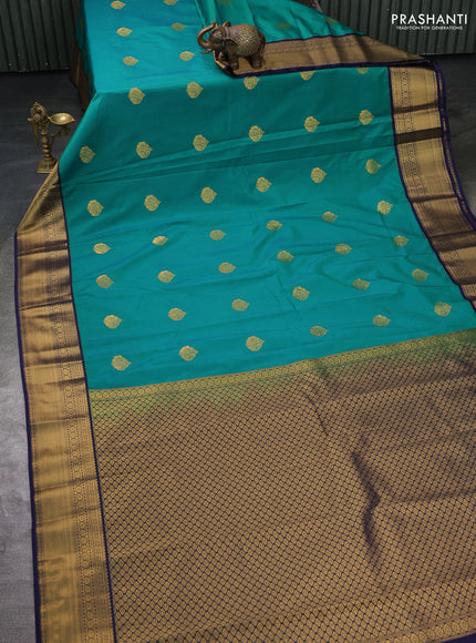 Semi kanchipuram silk saree green and navy blue with zari woven buttas and zari woven korvai border