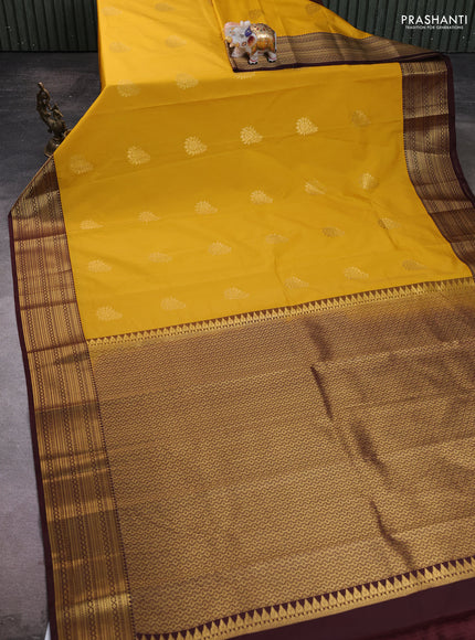 Semi kanchipuram silk saree yellow and coffee brown with zari woven buttas and zari woven korvai border