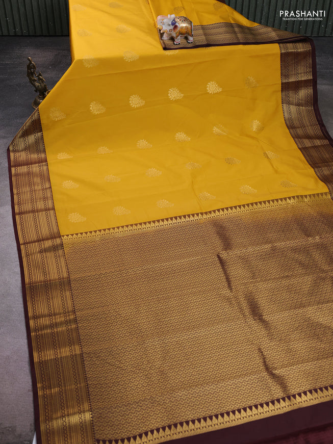 Semi kanchipuram silk saree yellow and coffee brown with zari woven buttas and zari woven korvai border