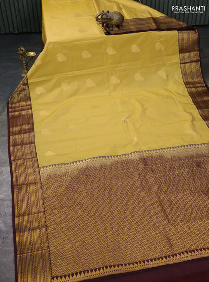 Semi kanchipuram silk saree yellow and brown with zari woven buttas and zari woven korvai border
