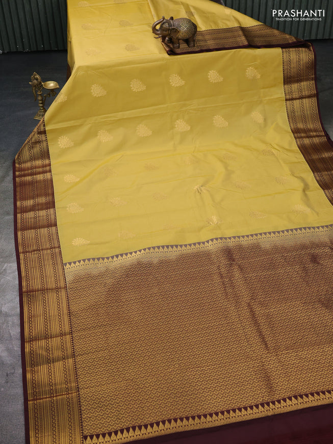 Semi kanchipuram silk saree yellow and brown with zari woven buttas and zari woven korvai border