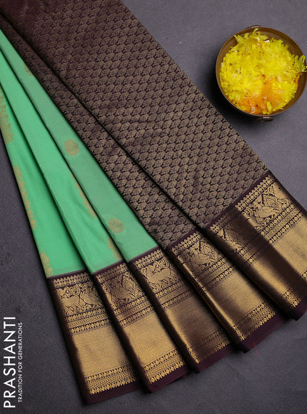 Semi kanchipuram silk saree light green and brown with zari woven buttas and zari woven koravi border