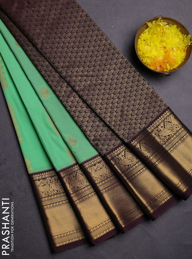 Semi kanchipuram silk saree light green and brown with zari woven buttas and zari woven koravi border