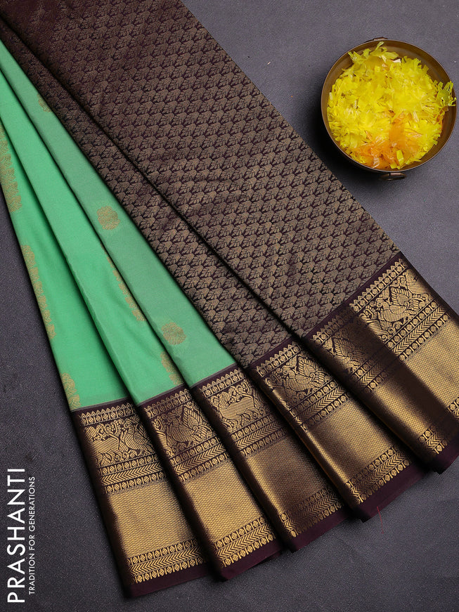 Semi kanchipuram silk saree light green and brown with zari woven buttas and zari woven koravi border
