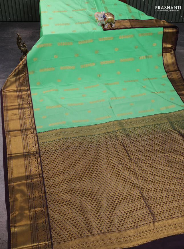 Semi kanchipuram silk saree light green and brown with zari woven buttas and zari woven koravi border