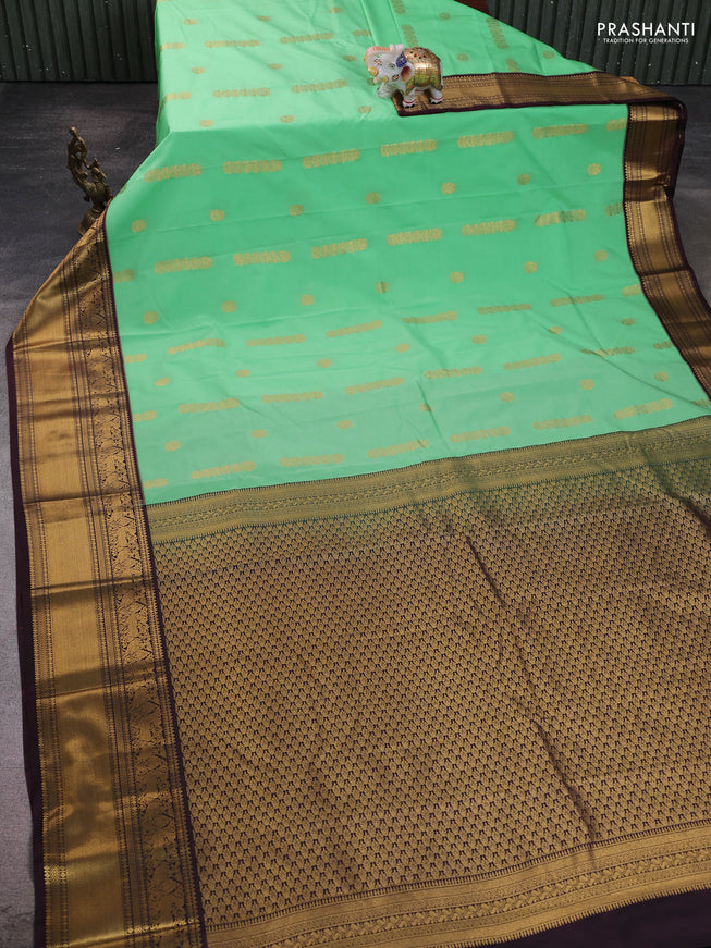 Semi kanchipuram silk saree light green and brown with zari woven buttas and zari woven koravi border
