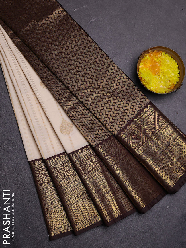 Semi kanchipuram silk saree off white and coffee brown with allover zari weaves and long zari woven border