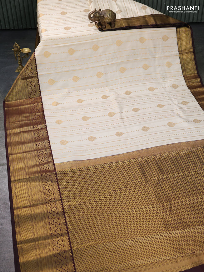 Semi kanchipuram silk saree off white and coffee brown with allover zari weaves and long zari woven border