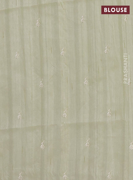 Semi raw silk saree pista green with embroidered buttas and embroidery border