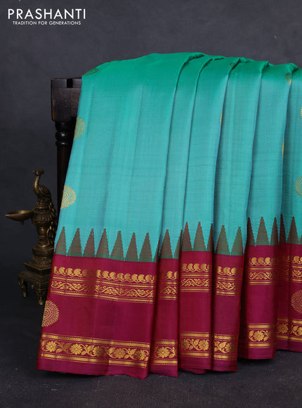 Pure gadwal silk saree teal green and dark magenta pink with zari woven buttas and temple design zari woven butta border