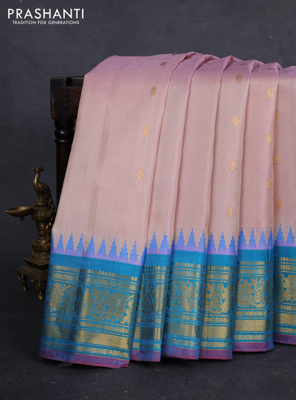 Pure gadwal silk saree pastel peach and dual tone teal green with zari woven buttas and temple design zari woven border