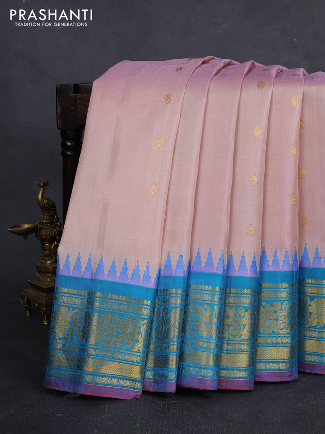 Pure gadwal silk saree pastel peach and dual tone teal green with zari woven buttas and temple design zari woven border