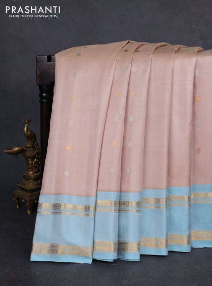 Pure gadwal silk saree sandal and light blue with silver & gold zari woven buttas and rettapet zari woven border