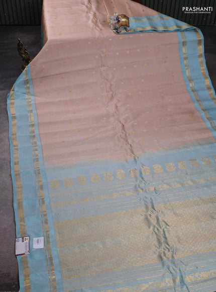 Pure gadwal silk saree sandal and light blue with silver & gold zari woven buttas and rettapet zari woven border