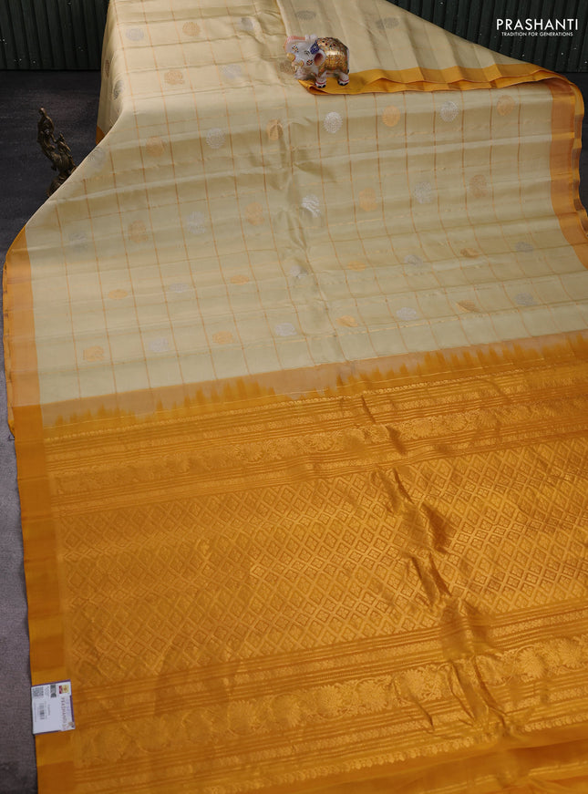 Pure gadwal silk saree cream and mustard yellow with allover zari checks & buttas and simple boder