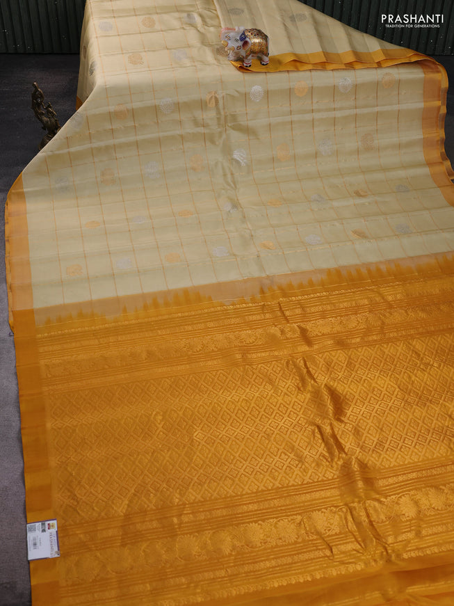 Pure gadwal silk saree cream and mustard yellow with allover zari checks & buttas and simple boder