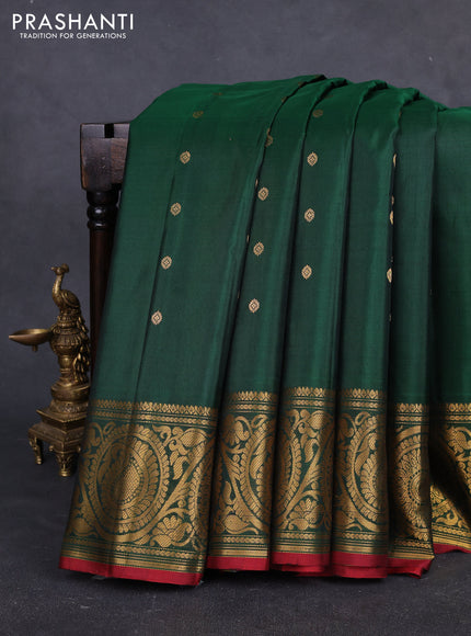 Pure gadwal silk saree bottle green with allover zari woven buttas and rich paisley zari woven border