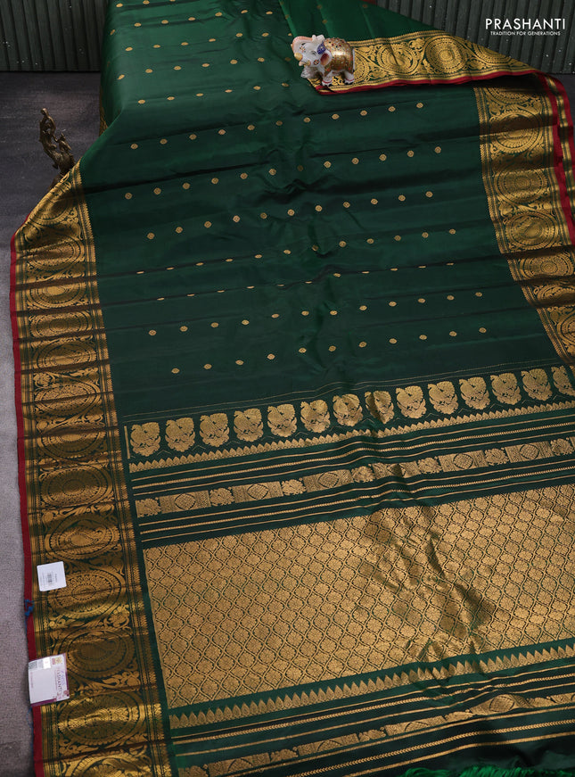 Pure gadwal silk saree bottle green with allover zari woven buttas and rich paisley zari woven border