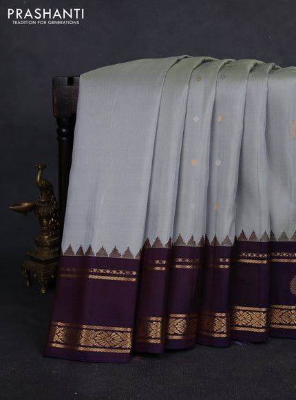 Pure gadwal silk saree grey and jamun shade with silver & gold zari woven buttas and rettapet zari woven border