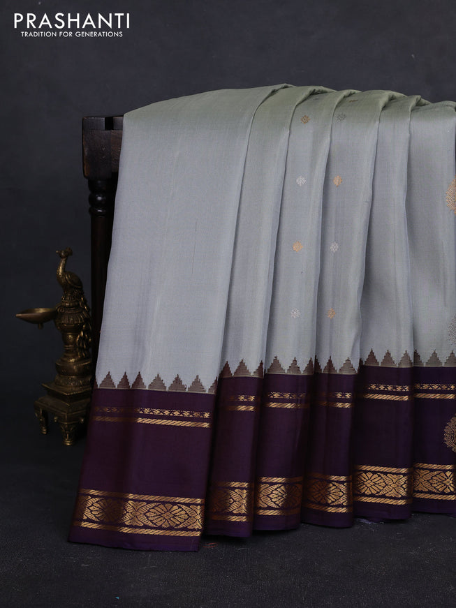 Pure gadwal silk saree grey and jamun shade with silver & gold zari woven buttas and rettapet zari woven border