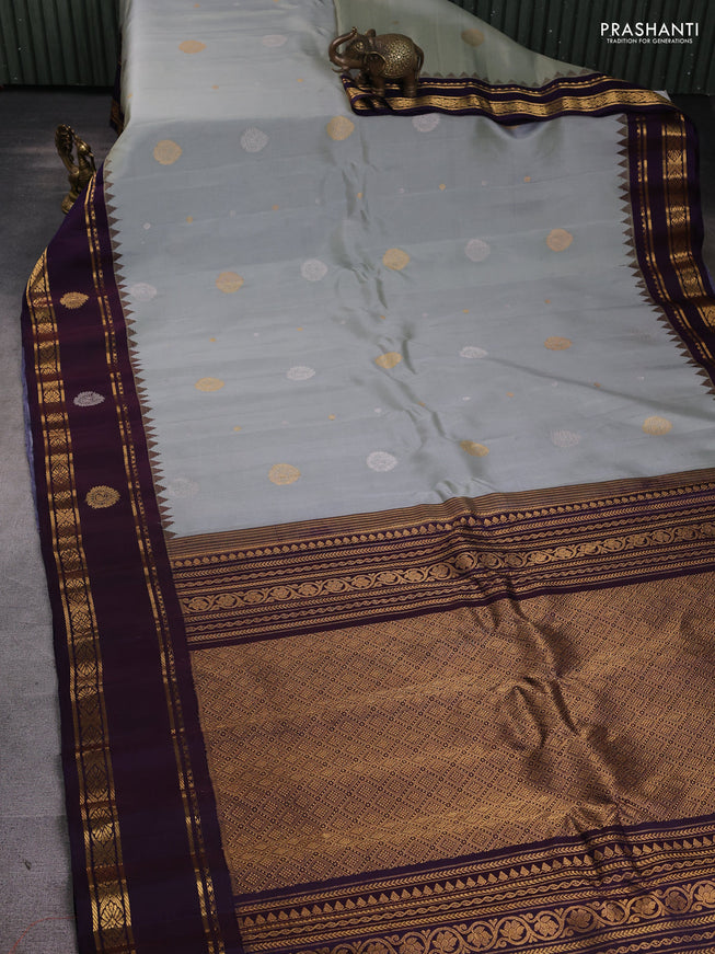 Pure gadwal silk saree grey and jamun shade with silver & gold zari woven buttas and rettapet zari woven border