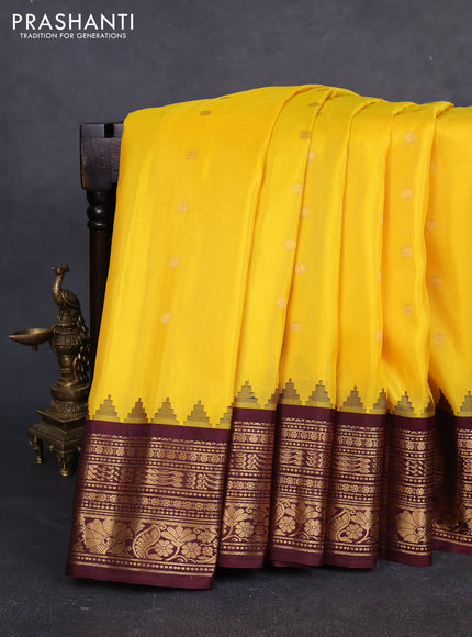 Pure gadwal silk saree yellow and deep maroon with allover zari woven buttas and temple design zari woven border
