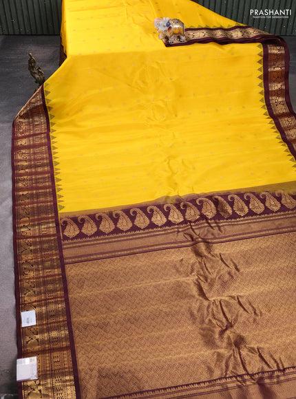 Pure gadwal silk saree yellow and deep maroon with allover zari woven buttas and temple design zari woven border