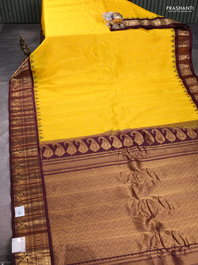 Pure gadwal silk saree yellow and deep maroon with allover zari woven buttas and temple design zari woven border