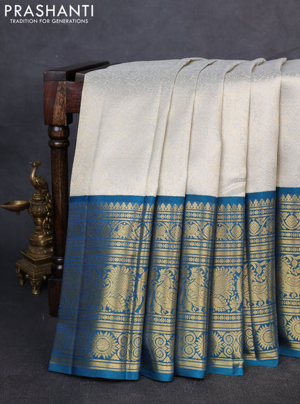 Pure kanchipuram Silk Saree pastel grey and peacock green with allover zari woven brocade weaves and long rich zari woven korvai border