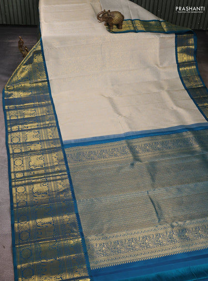 Pure kanchipuram Silk Saree pastel grey and peacock green with allover zari woven brocade weaves and long rich zari woven korvai border