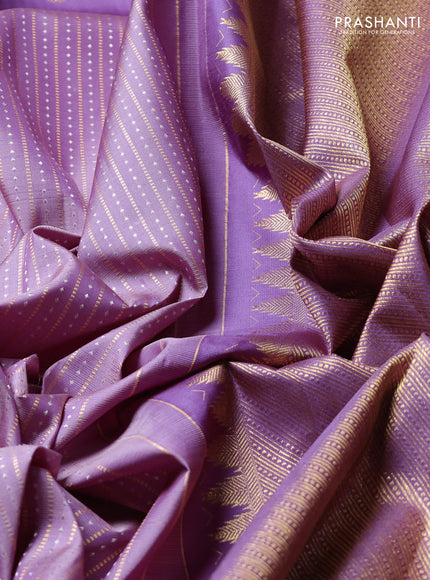 Pure Kanchipuram Silk Saree pastel purple and mild purple with allover silver & gold zari weaves and long zari woven butta border