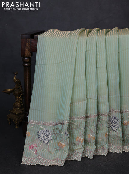 Organza saree pastel green with allover zari stripe pattern and floral convent embroidery border