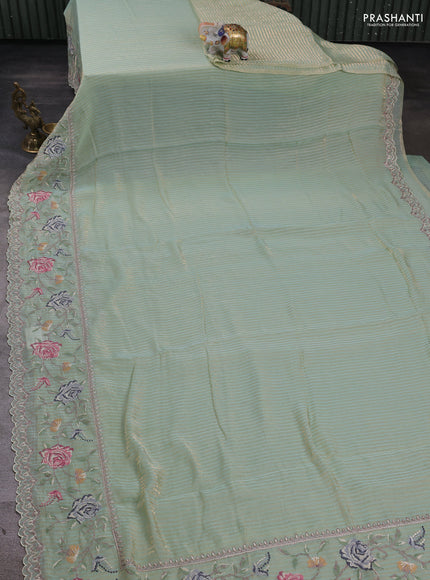 Organza saree pastel green with allover zari stripe pattern and floral convent embroidery border