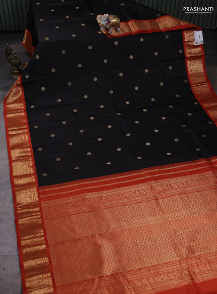 Pure kanchipuram silk saree black and orange with zari woven buttas and zari woven korvai border