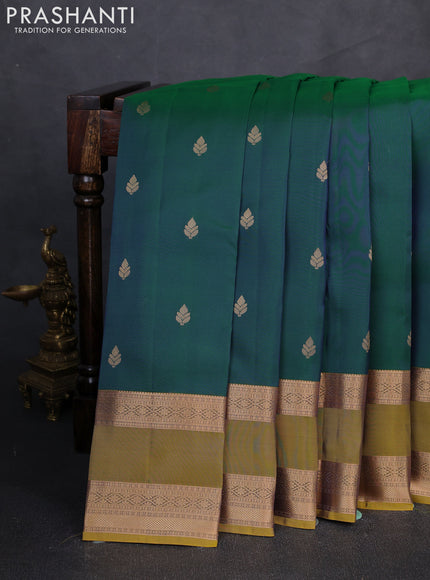Kanchipuram silk saree dual tone peacock blue and dark mustard with zari woven buttas and rettapet zari woven border