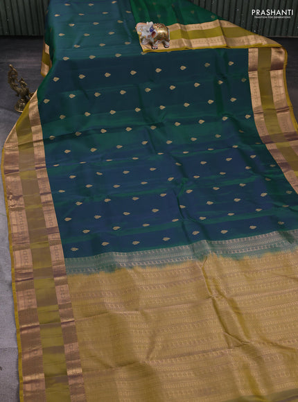Kanchipuram silk saree dual tone peacock blue and dark mustard with zari woven buttas and rettapet zari woven border