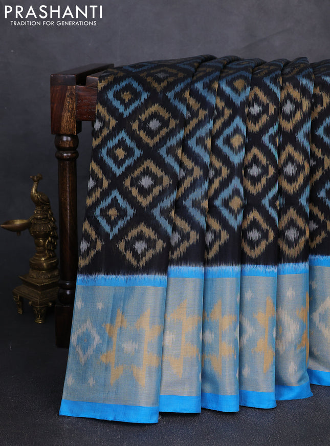 Ikat silk cotton saree black and cs blue with allover ikat weaves and long zari woven border