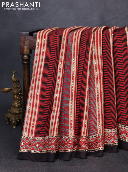 Modal silk saree rust shade and black with allover ajrakh prints & sequin mirror work and sequin embroidery pallu
