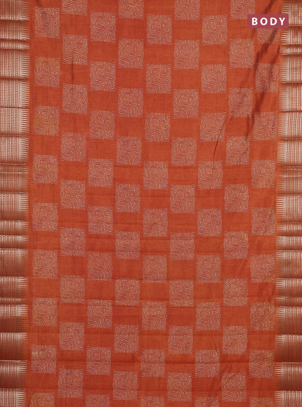 Semi raw silk saree rust shade with allover box type butta prints and zari woven border