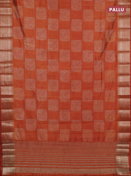 Semi raw silk saree rust shade with allover box type butta prints and zari woven border