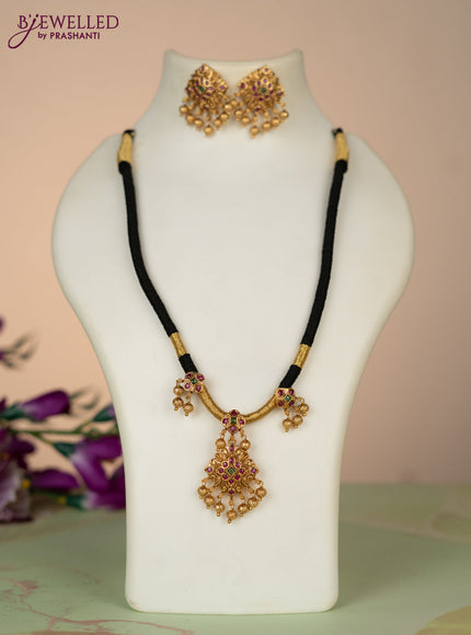 Black thread necklace with kemp stones and golden beads hangings