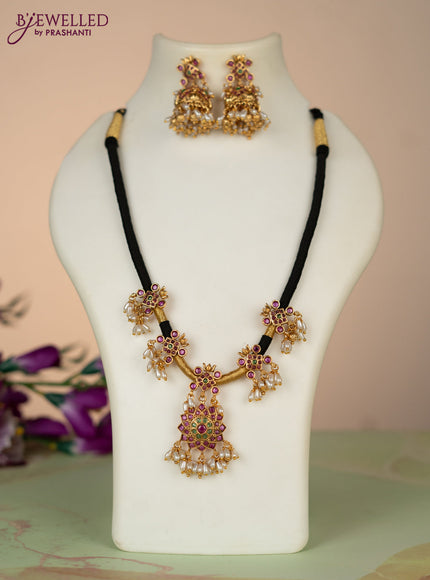 Black thread necklace with kemp stones and pearl & golden beads hangings