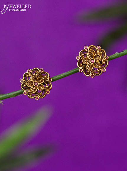 Antique earrings with floral design and ruby stones